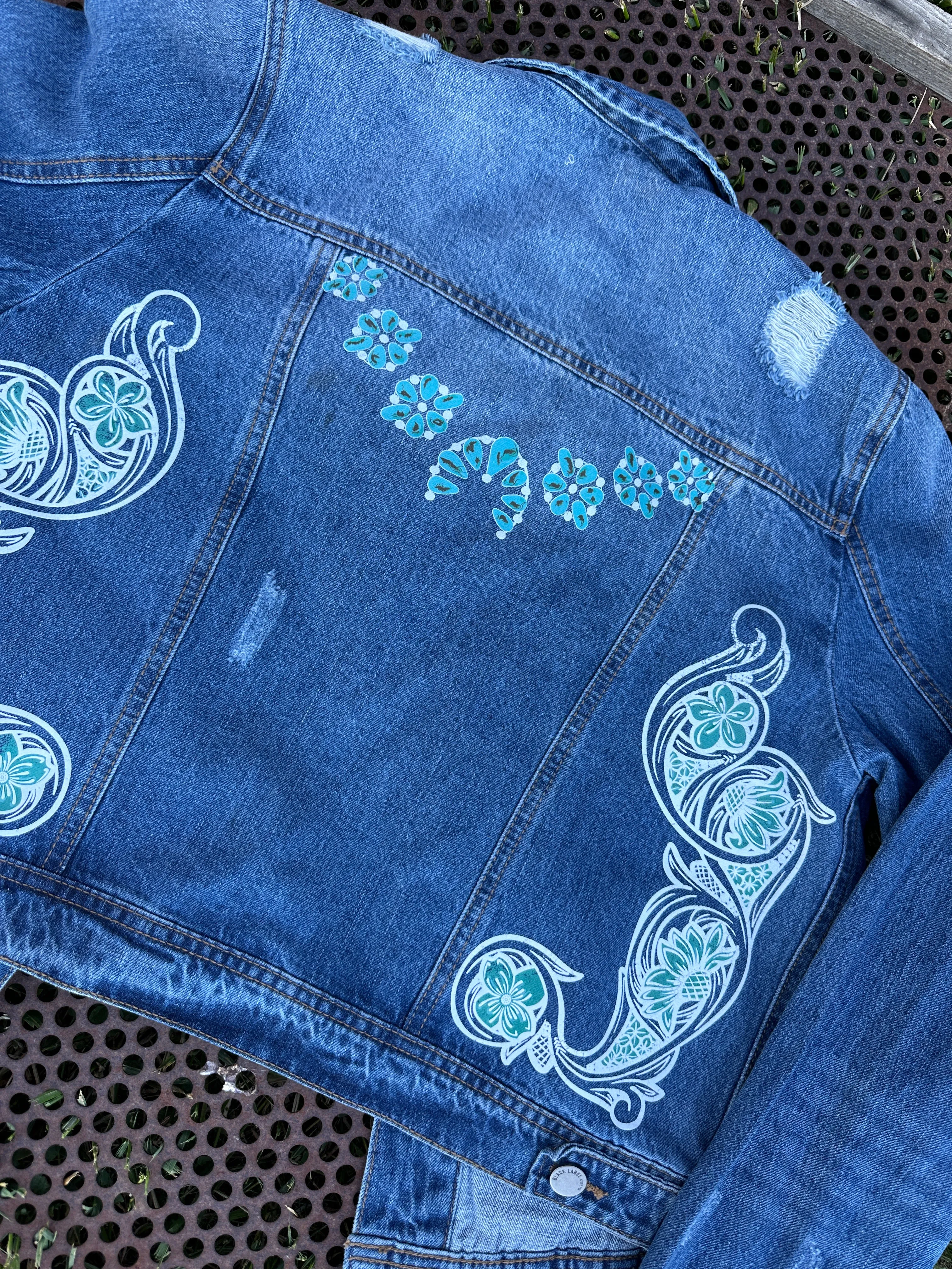 Denim jacket with Squash Blossom and tooled sides.