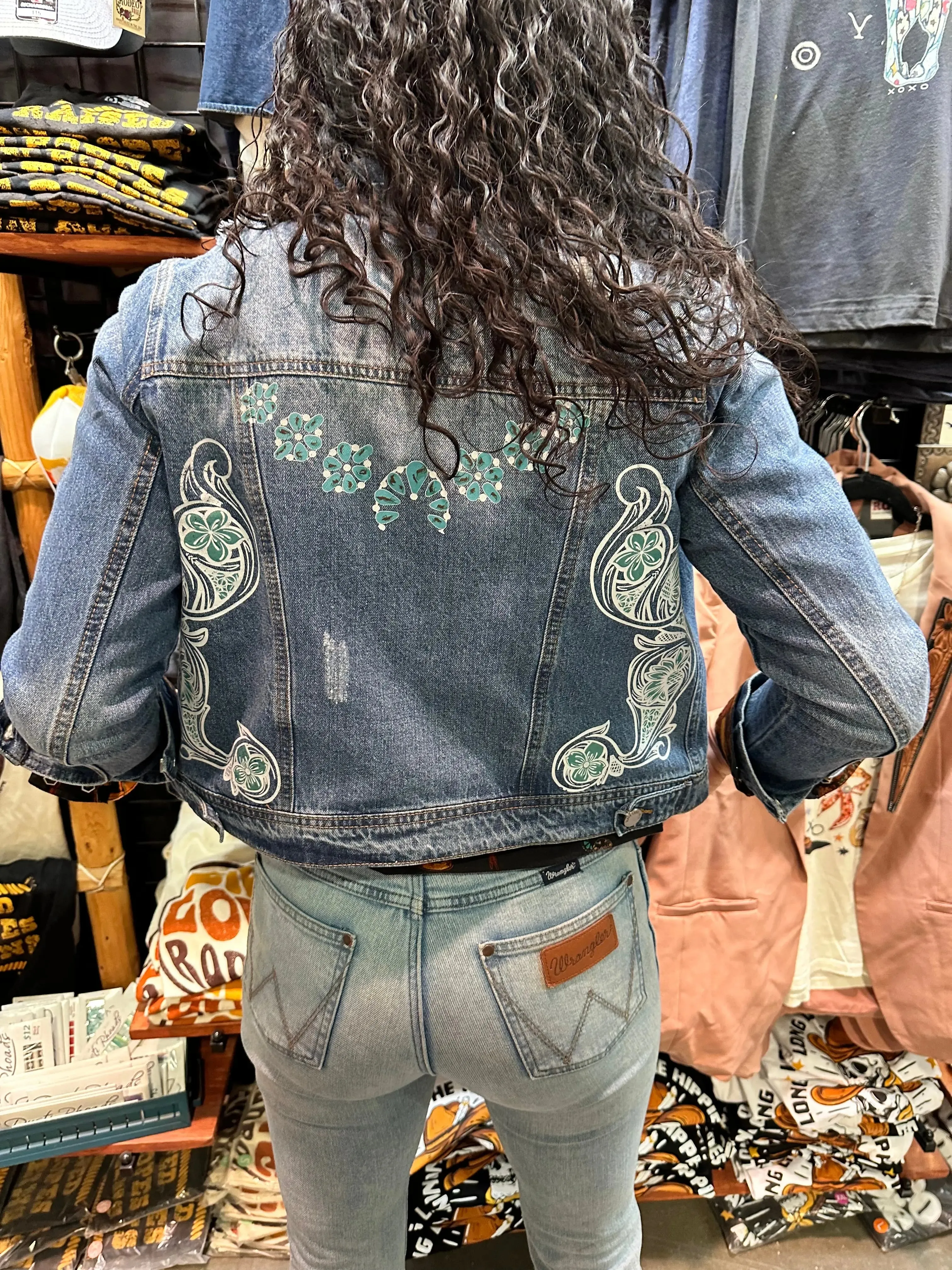 Denim jacket with Squash Blossom and tooled sides.