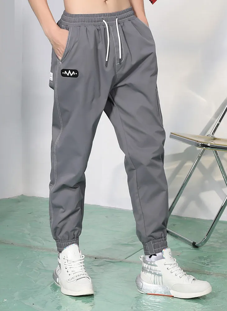 Plain Label Asymmetric Pocket Drawstring Casual Pants